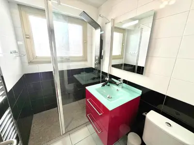 a bathroom with a red sink and a mirror at Branly 2, by Welcome to Cannes in Cannes