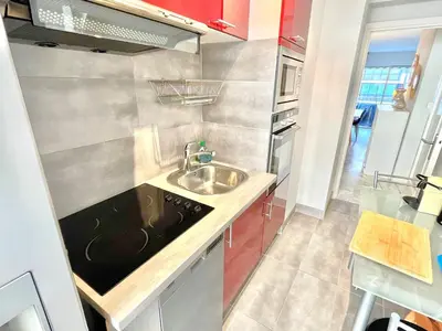 a small kitchen with a sink and a stove at Branly 2, by Welcome to Cannes in Cannes