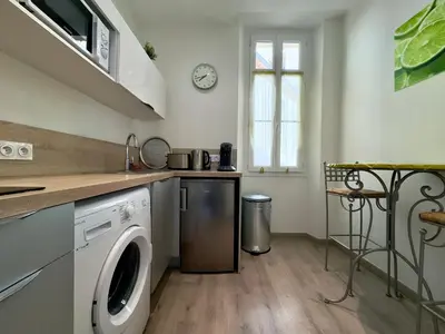 a kitchen with a washer and dryer in it at Vénus By SCLS Locations in Cannes