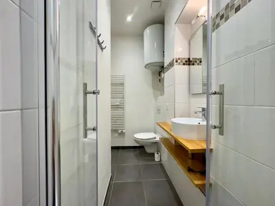 a white bathroom with a sink and a toilet at Vénus By SCLS Locations in Cannes