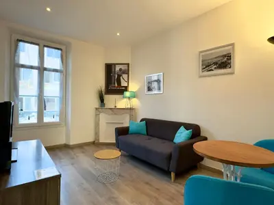 a living room with a couch and a table at Vénus By SCLS Locations in Cannes