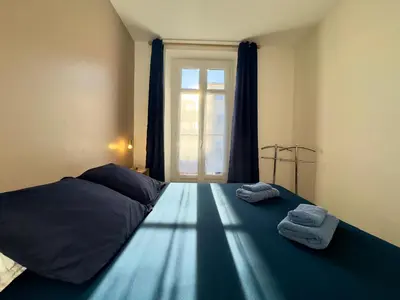 a bedroom with a bed with two towels on it at Vénus By SCLS Locations in Cannes