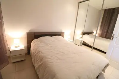 a bedroom with a large bed and two mirrors at Carré d'Or 1 bedroom 2 mins from Croisette 5 from Palais 243 in Cannes