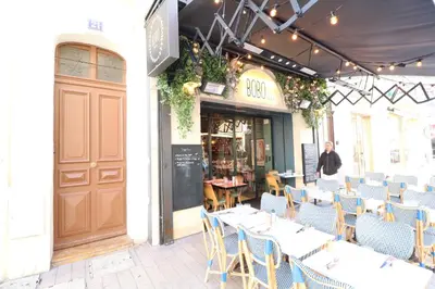 a restaurant with tables and chairs in front of a building at Carré d'Or 1 bedroom 2 mins from Croisette 5 from Palais 243 in Cannes