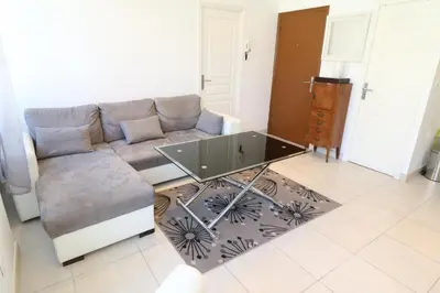 a living room with a couch and a glass table at Carré d'Or 1 bedroom 2 mins from Croisette 5 from Palais 243 in Cannes