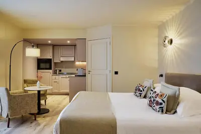 a hotel room with a bed and a kitchen at Villa d'Estelle in Cannes