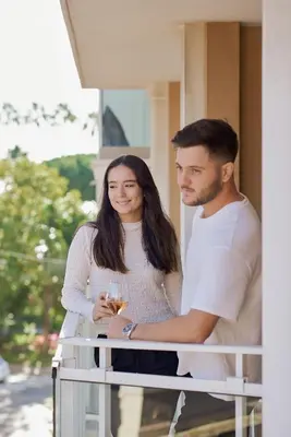 a man and a woman standing on a balcony at Villa d'Estelle in Cannes