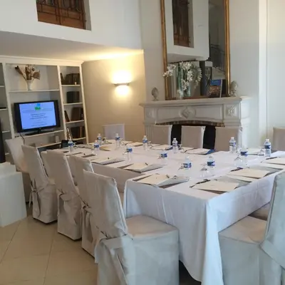 a large room with tables and chairs and a television at Villa d'Estelle in Cannes