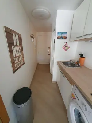 a small kitchen with a sink and a trash can at L'Estérel in Cannes