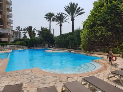 a person standing in front of a swimming pool at L'Estérel in Cannes