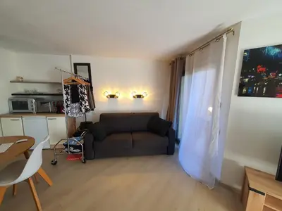 a living room with a couch and a table at L'Estérel in Cannes