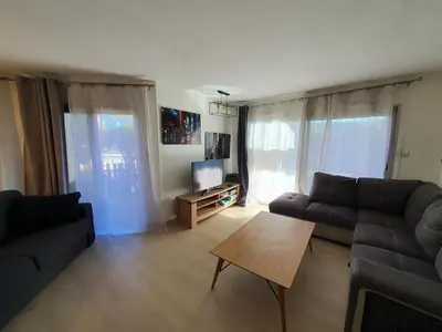 a living room with a couch and a table at L'Estérel in Cannes