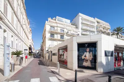 a building with a poster of a man in a window at Near Croisette- 4 Star Studio -SeaView in Cannes