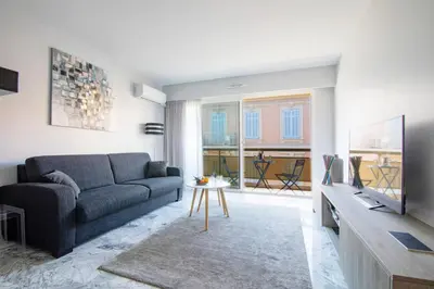 a living room with a couch and a tv at Near Croisette- 4 Star Studio -SeaView in Cannes