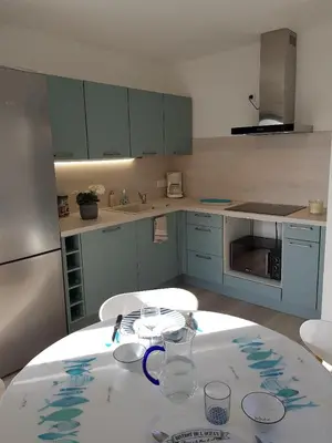 a kitchen with a table with glasses on it at A little Eden in Le Cannet