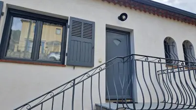 a house with a staircase and a door and windows at A little Eden in Le Cannet