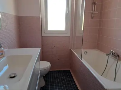 a bathroom with a toilet and a tub and a sink at LES MOUETTES A in Cannes