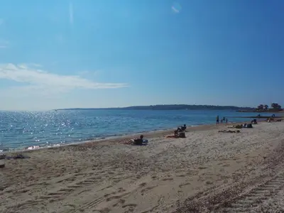 a group of people on a beach near the water at LES MOUETTES A in Cannes