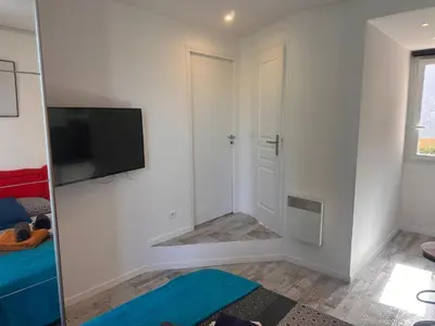 a room with a flat screen tv on a wall at Studio and gallery in Cannes