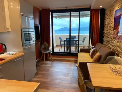 a kitchen and living room with a view of the ocean at ToiTmer in Cannes