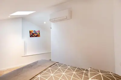 a bedroom with a bed and a wall at Atelier Duplex in Cannes