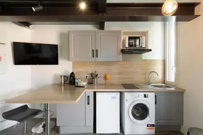 a kitchen with a washing machine and a sink at Atelier Duplex in Cannes