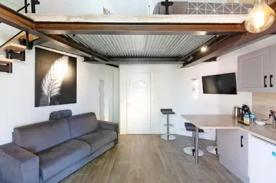 a living room with a couch and a table at Atelier Duplex in Cannes