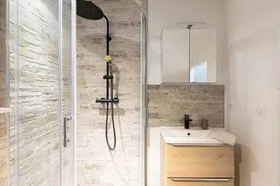 a bathroom with a shower and a sink at Atelier Duplex in Cannes