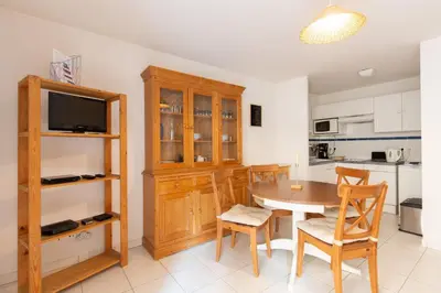 a kitchen and dining room with a table and chairs at Palazzio Vieux Port by Welcome to Cannes in Cannes