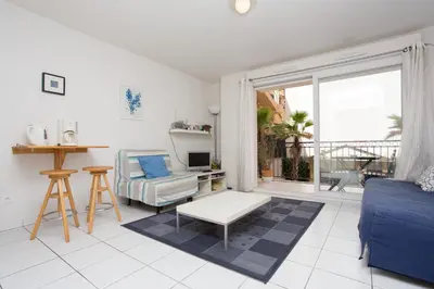 a living room with a couch and a chair at Palazzio Vieux Port by Welcome to Cannes in Cannes