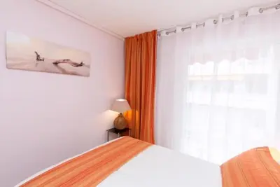 a bedroom with a bed and a window at Magnifique 2 pièces Palm Beach bord mer in Cannes