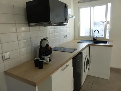 a small kitchen with a sink and a microwave at LE 31 in Cannes
