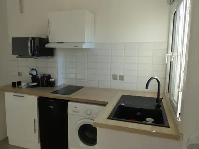 a kitchen with a sink and a washing machine at LE 31 in Cannes