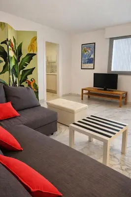a living room with a couch and a coffee table at La vue d'Azur, élégance et lumière à Cannes in Cannes