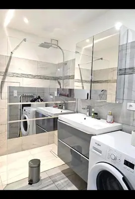 a bathroom with two sinks and a washing machine at La vue d'Azur, élégance et lumière à Cannes in Cannes