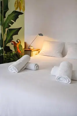 a bedroom with two beds with towels on them at La vue d'Azur, élégance et lumière à Cannes in Cannes