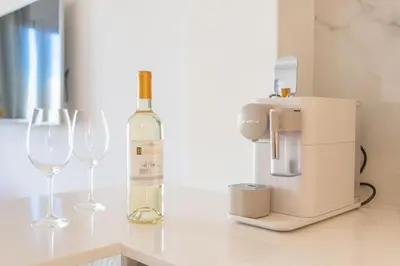 a bottle of wine and two wine glasses on a counter at Luxury Apartment - 150m to Palais des Festivals ( Cannes ) in Cannes