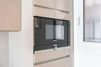 a microwave oven sitting inside of a door at Luxury Apartment - 150m to Palais des Festivals ( Cannes ) in Cannes