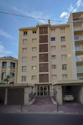 an apartment building with a parking lot in front of it at IMMOGROOM - Panoramic View - quiet - AC - bright in Cannes