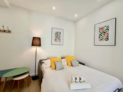 a small bedroom with a bed and a desk at Brand-New 1 Bedroom Fully Refurbished in Cannes