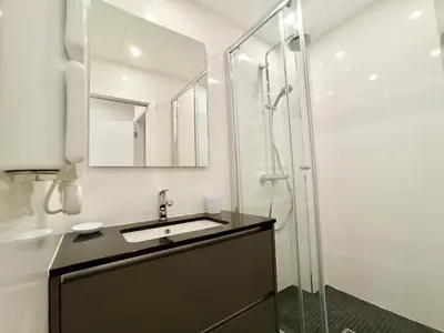 a bathroom with a sink and a shower at Brand-New 1 Bedroom Fully Refurbished in Cannes