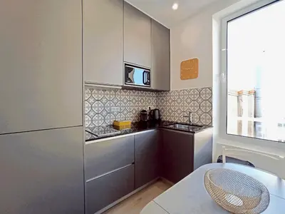 a kitchen with a refrigerator and a counter top at Brand-New 1 Bedroom Fully Refurbished in Cannes