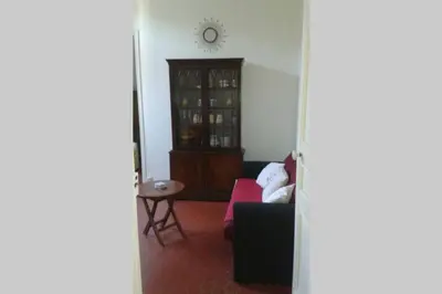 a living room with a couch and a clock on the wall at CANNES in Cannes