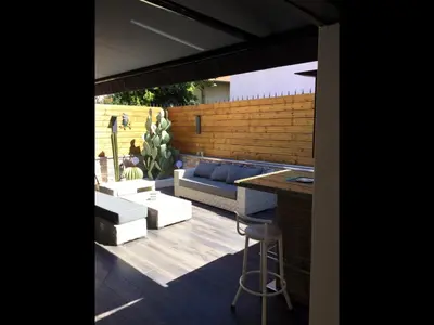 a patio with a couch and a table and chairs at VILLA OCEANE in Cannes