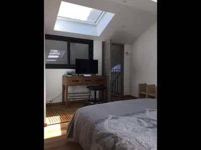 a bedroom with a bed and a desk and a window at VILLA OCEANE in Cannes
