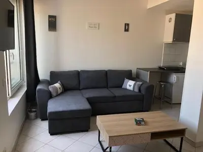 a living room with a couch and a coffee table at Studio CENTRE CROISETTE in Cannes