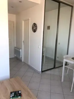 a room with a door and a clock on the wall at Studio CENTRE CROISETTE in Cannes
