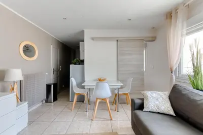 a living room with a couch and a table at Cosy apartment + secured PARKING in Cannes