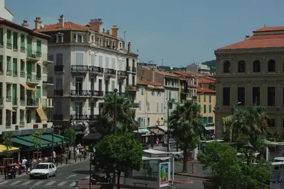 a city street with buildings and a car on the road at Studio Léa in Cannes