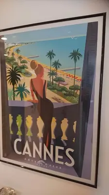 a painting of a woman on a balcony with a beach at Nicolas 8 in Cannes
